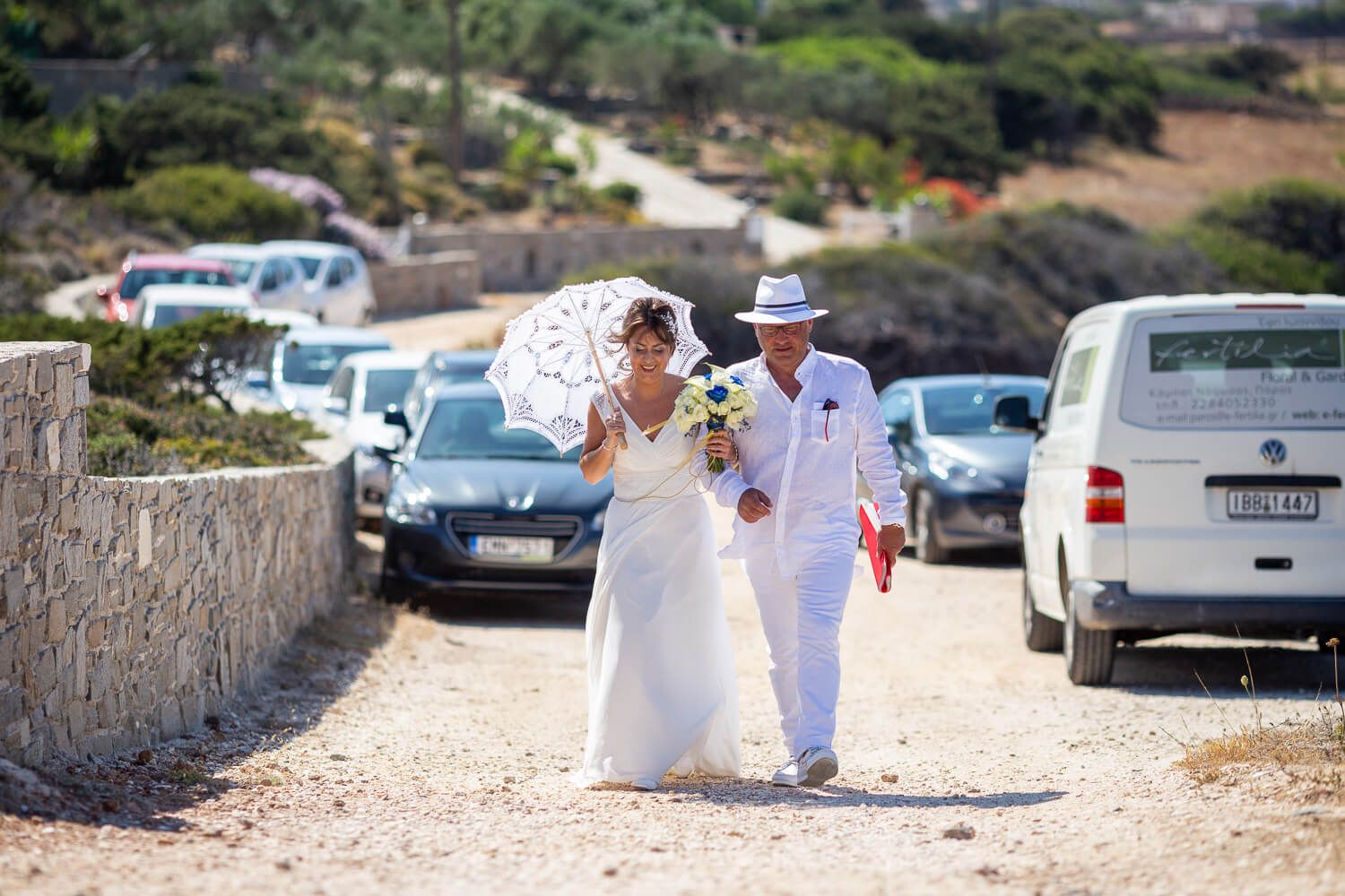 Father escorting the bride at a symbolic wedding ceremony at Pyrgaki Paros