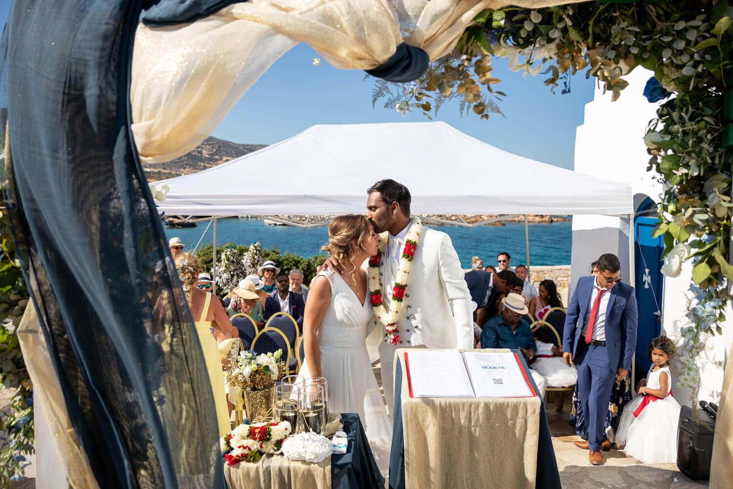 Couple kissing after their wedding at  Pyrgaki chapeli in Paros Greece