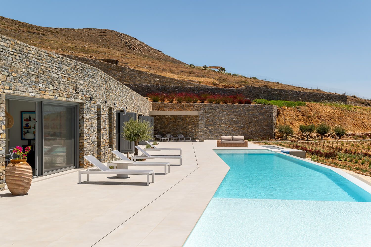 Modern Cycladic villa showcasing a pristine exterior pool and geometric lines.