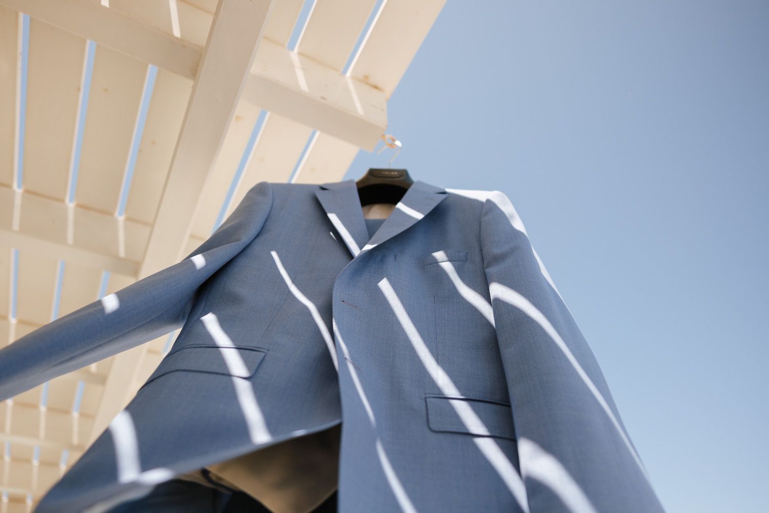 Groom's suit hanging under the Cycladic sky
