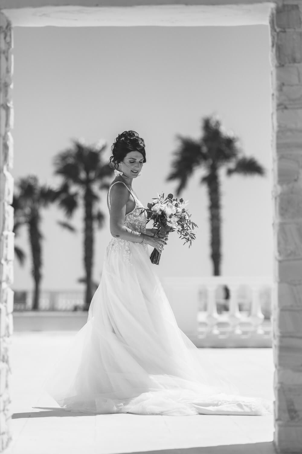 Black and white photo of the bride Bride Erika posing before her Catholic Italian wedding in Paros at Villa Aethra