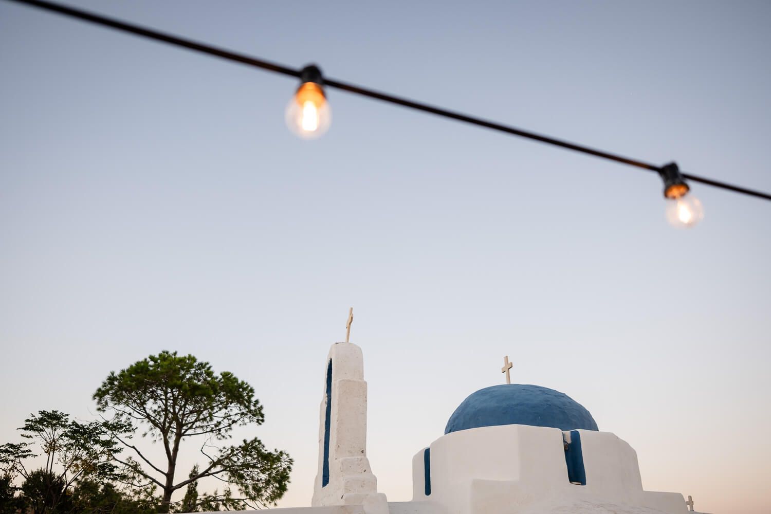 Wide landscape shot of The Secret View venue in Paros under the blue sky