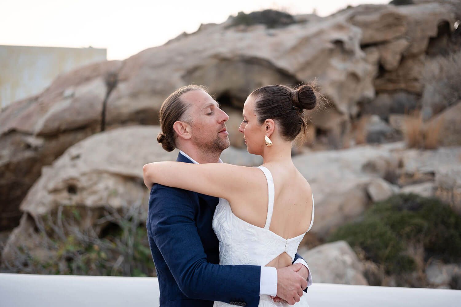 Romantic embrace of the married couple right after their Paros ceremony