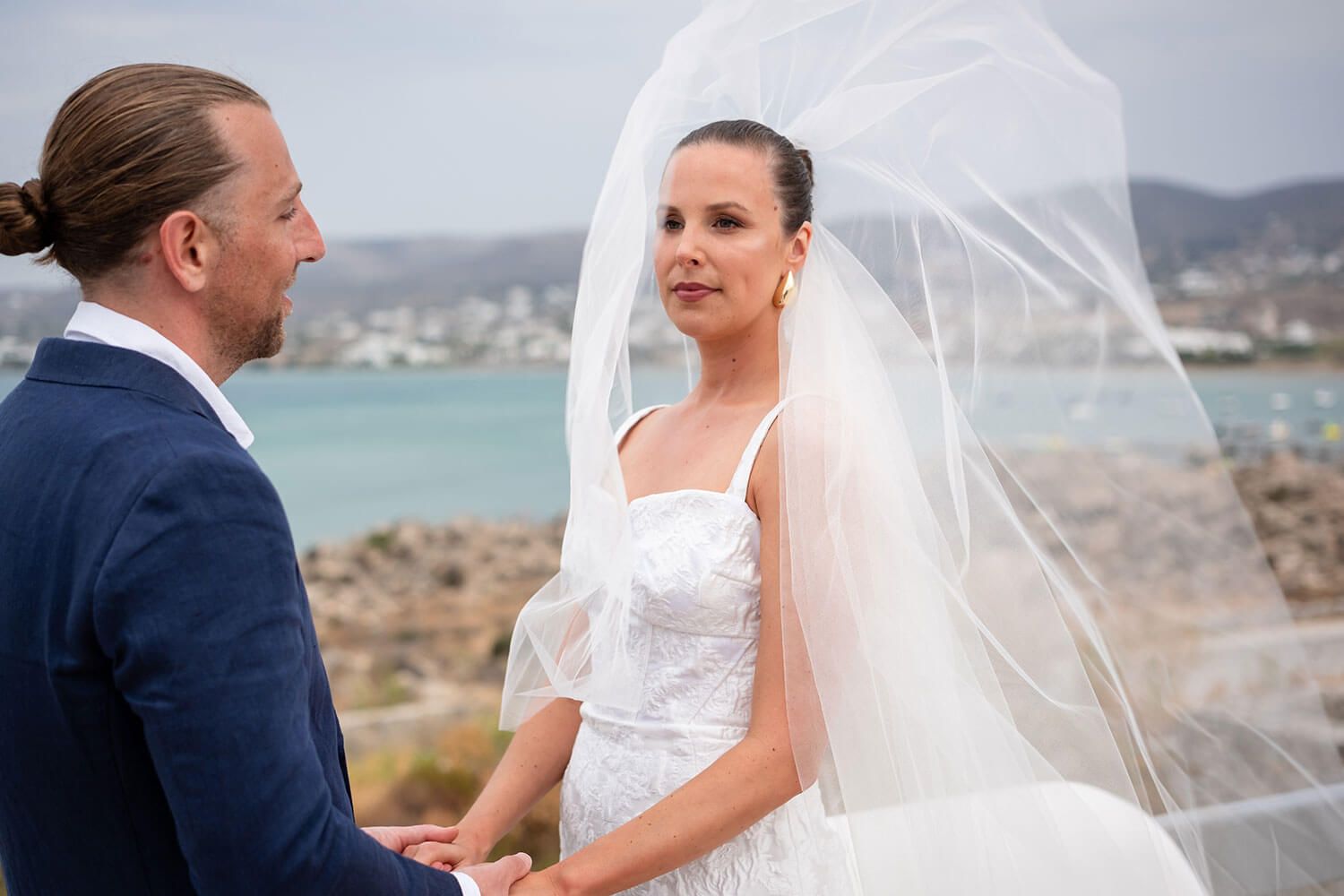 Couple holding hands during their intimate wedding ceremony in Paros