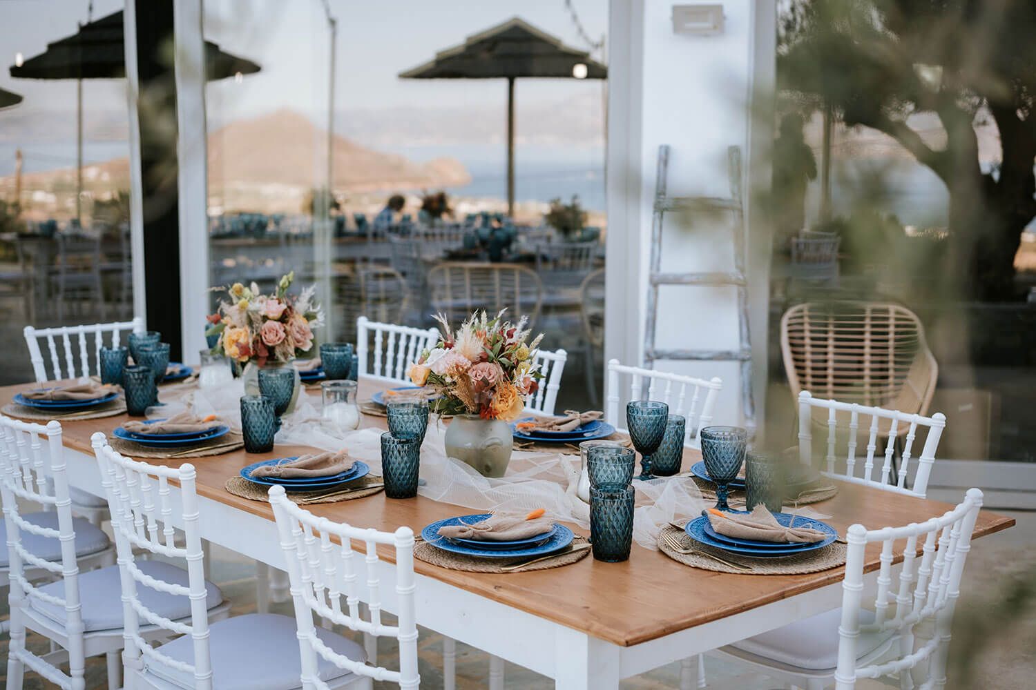 Outdoor wedding reception tables with boho decor in Paros Greece