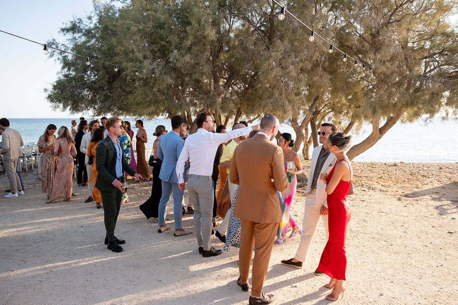 Friends and family mingling by the Aegean Sea in Aliki village