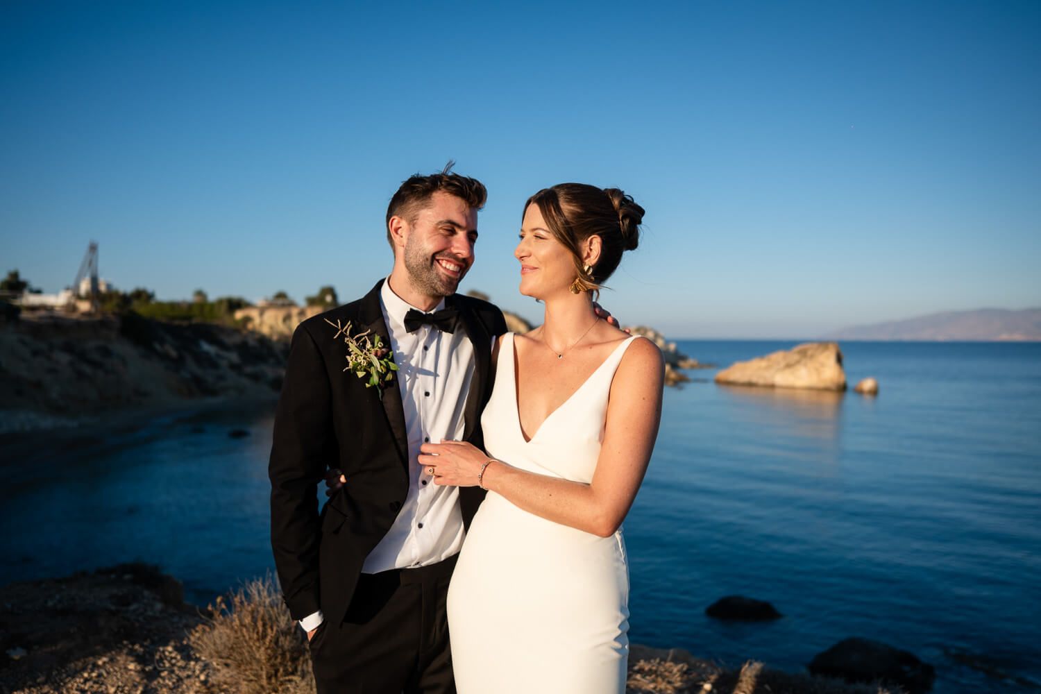 Golden hour light illuminating the happy newlyweds in Paros