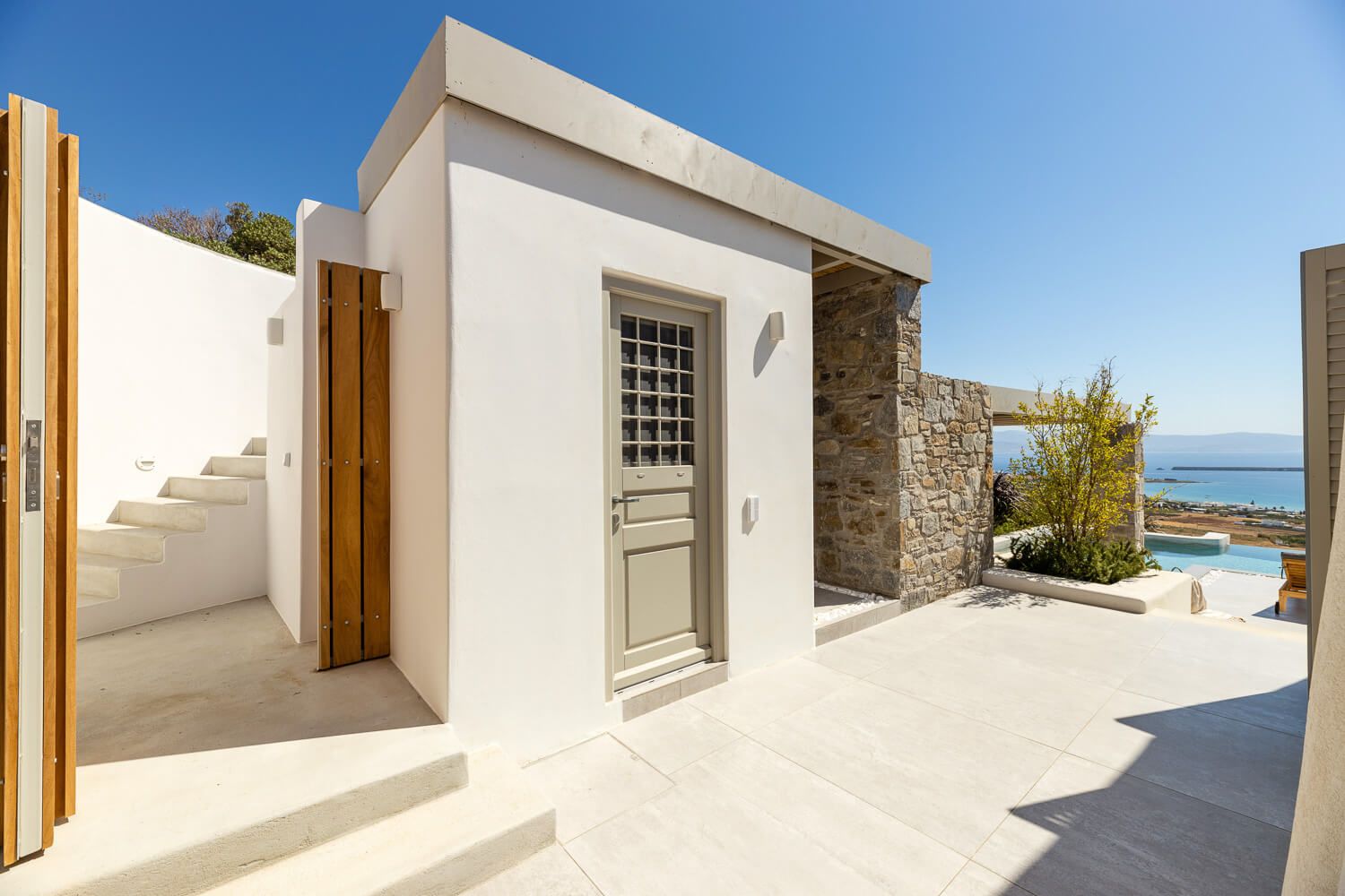 Clean architectural lines framing the Aegean Sea panorama