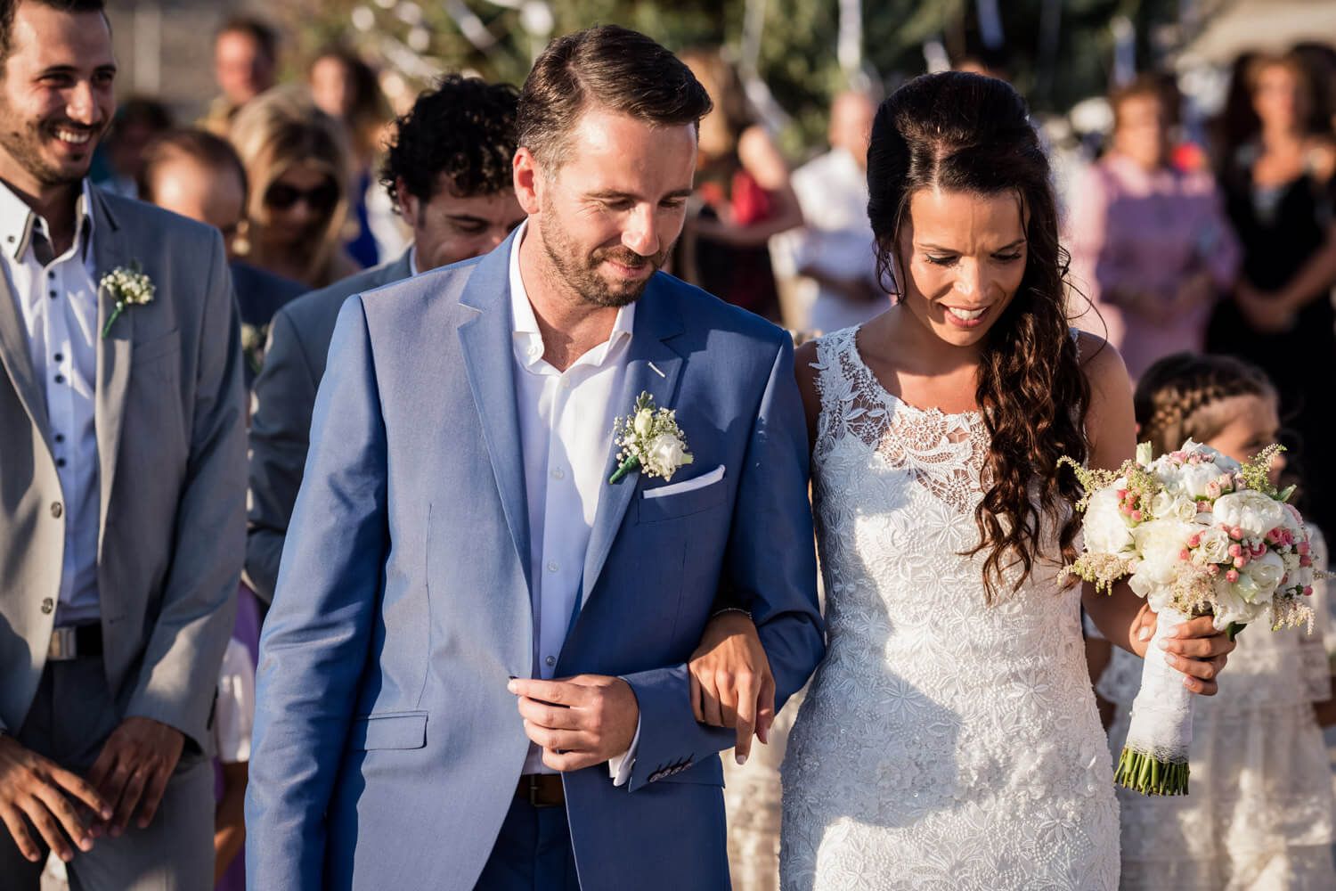 Couple entering at a Wedding ceremony at Agios Konstantinos church by the sea in Milos