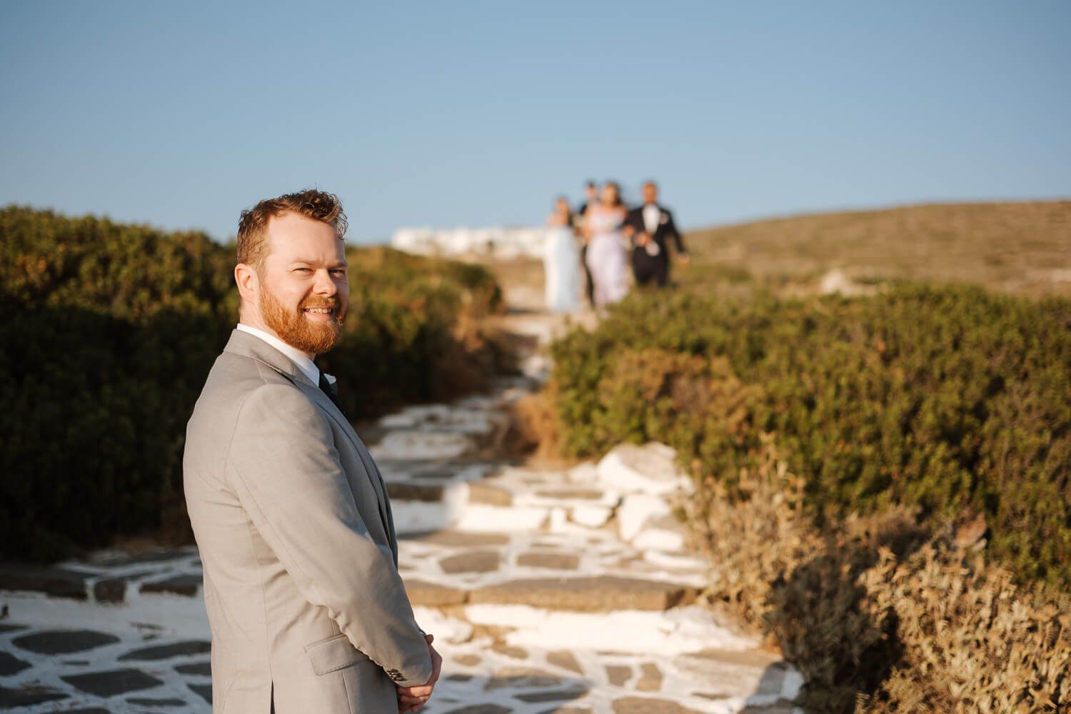 Groom waiting for the bride to come at a hilltop chapel in Paros