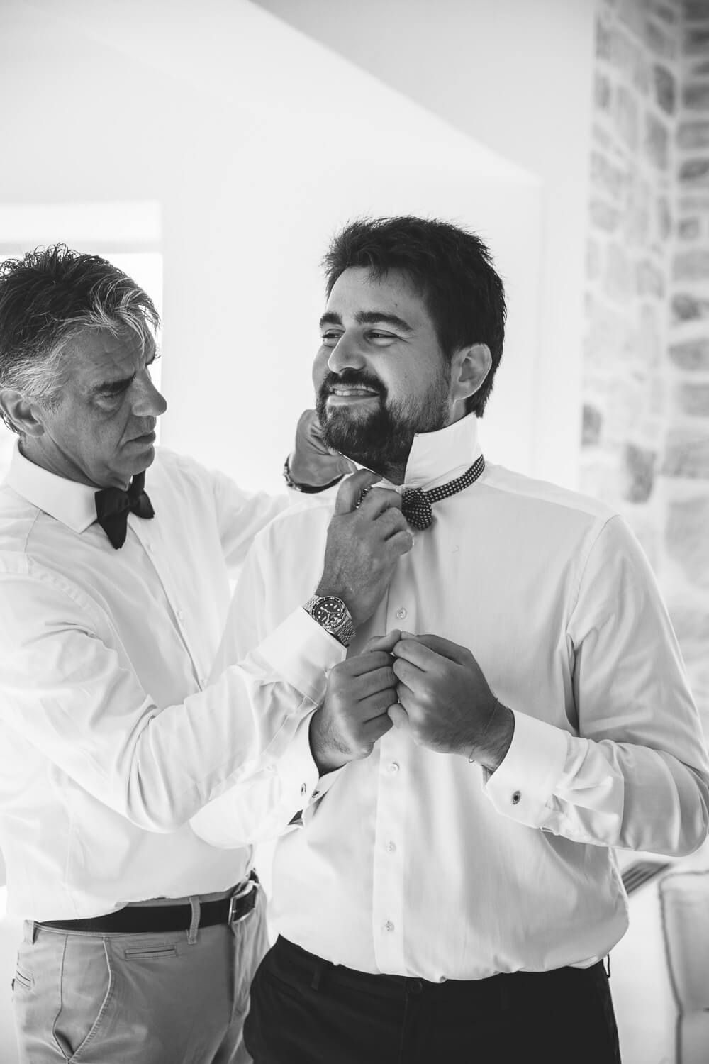 Black and white portrait of the groom during preparation in Paros