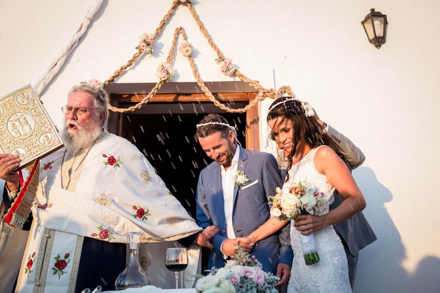 Guests throwing rice at the newlyweds - Greek wedding tradition
