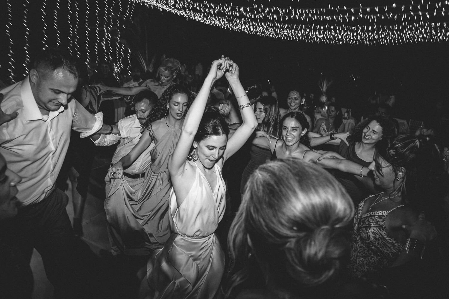 Guests flooding the dance floor under the atmospheric venue lighting
