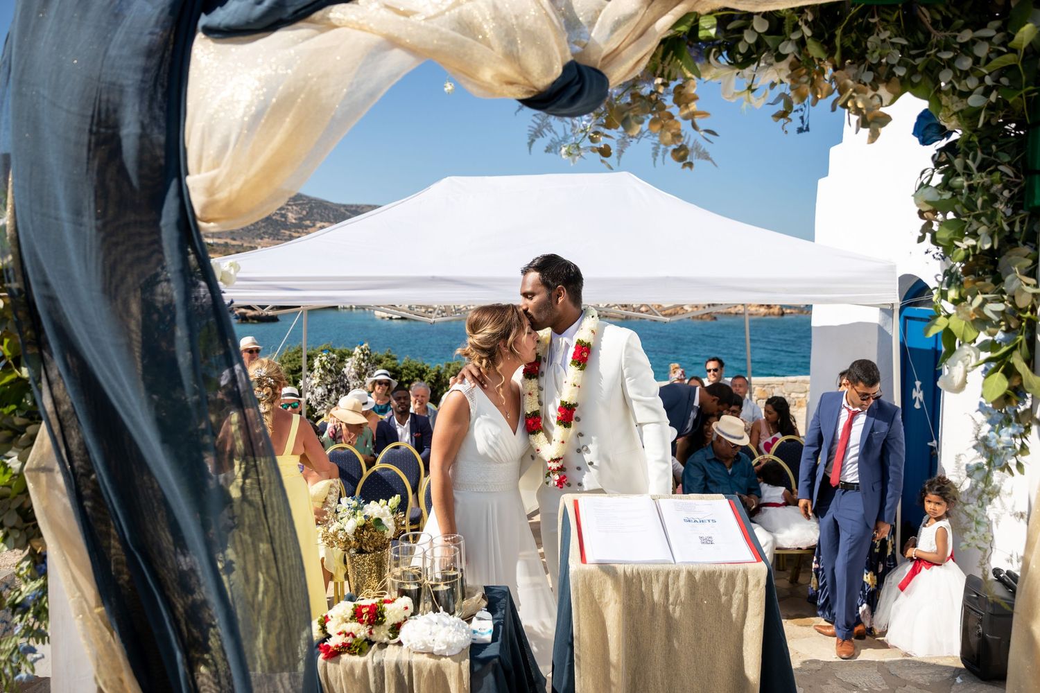 Wide landscape shot of the outdoor wedding ceremony with Aegean Sea views