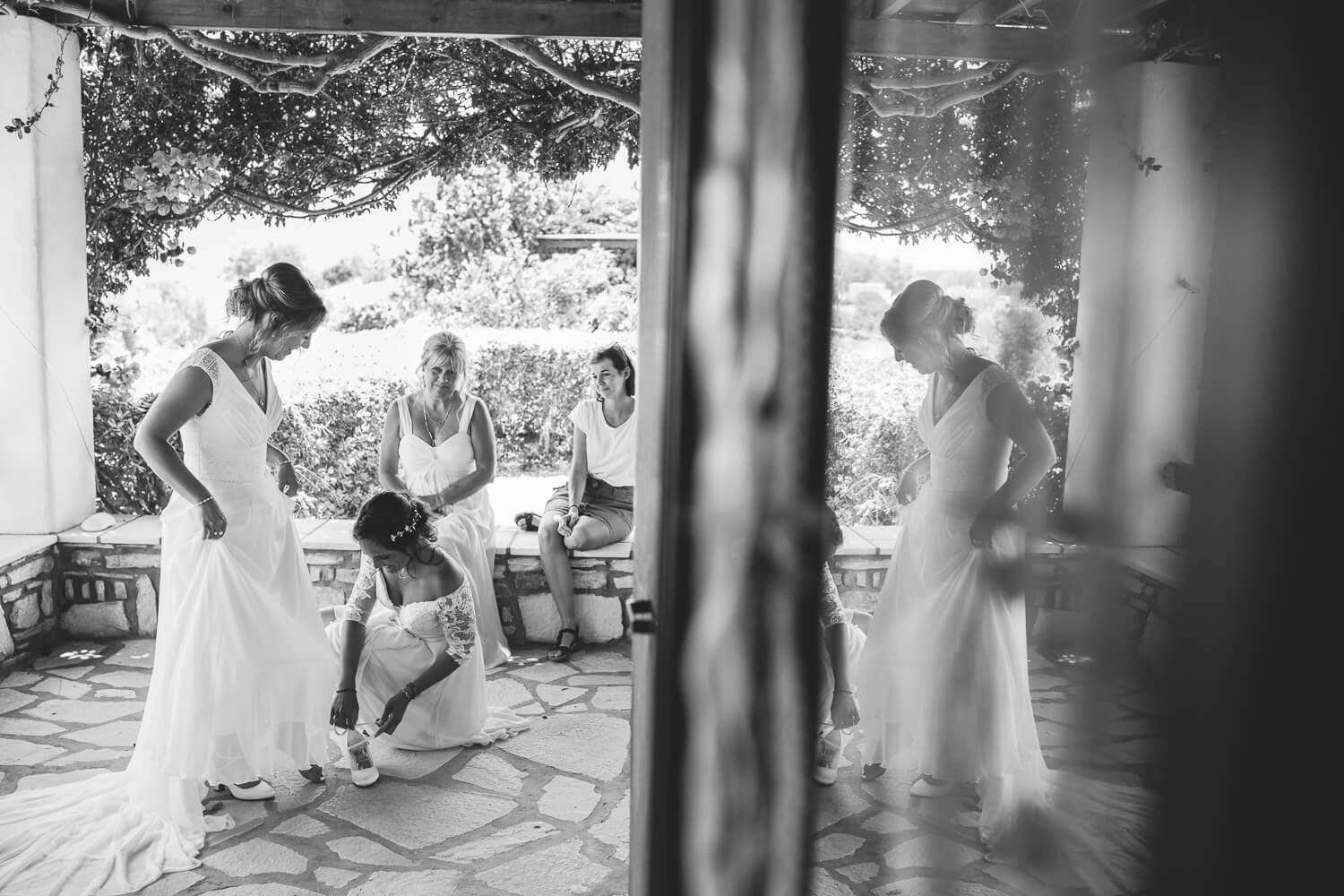 Bride putting on her elegant wedding dress in the Cyclades