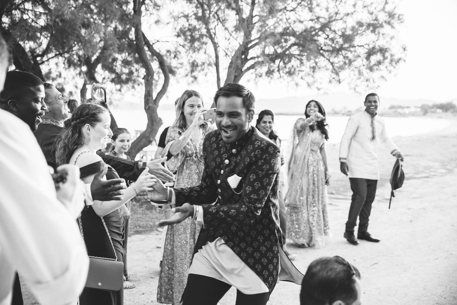 Groom dancing outside Thalassamou restaurant before the wedding dinner