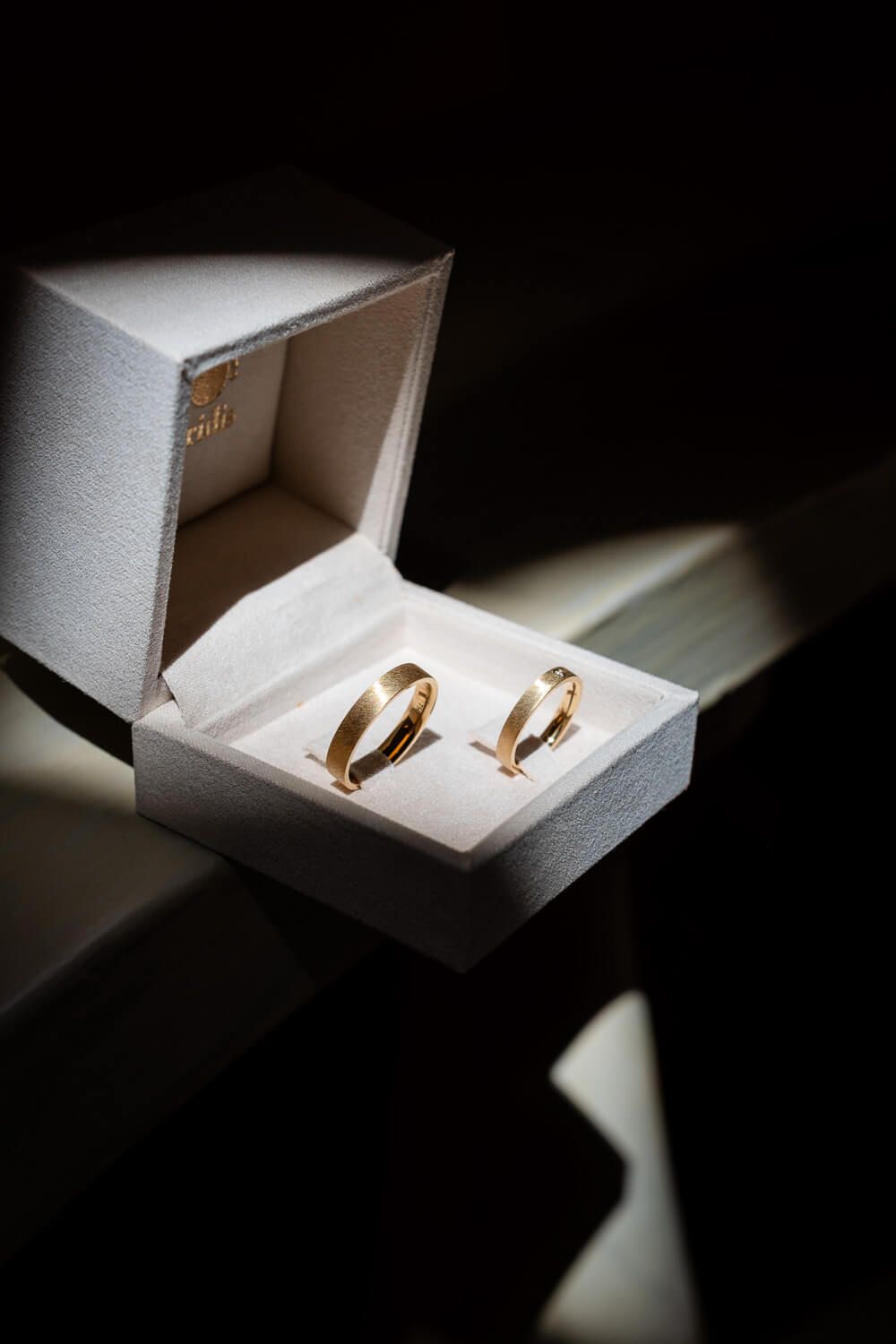 Close up of wedding rings in a neoclassical room