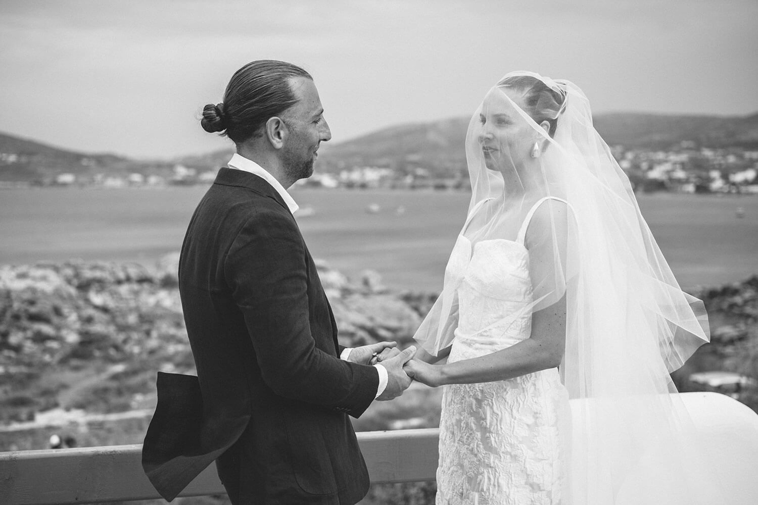 Couple holding hands during their intimate wedding ceremony in Paros
