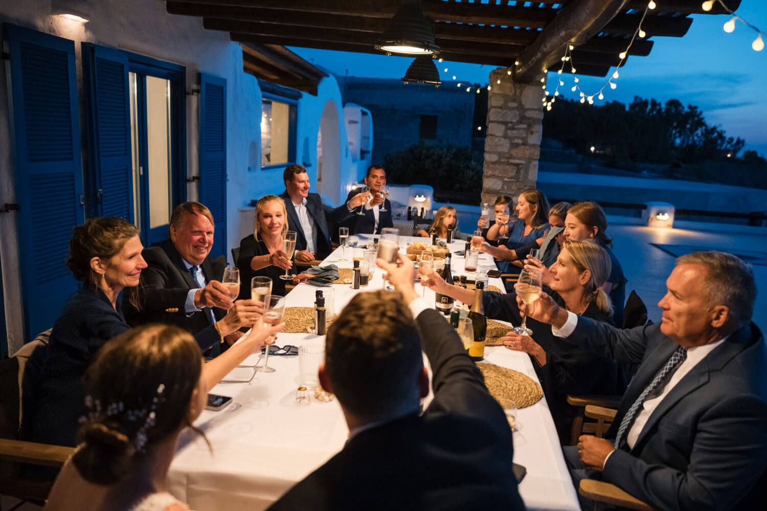 Lizzy and Cody making a toast at their private elopement dinner