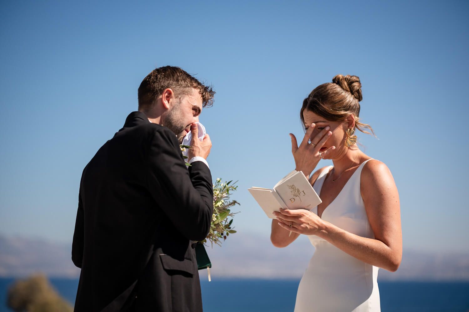 Jess wiping away a tear while reading her vows privately in Paros