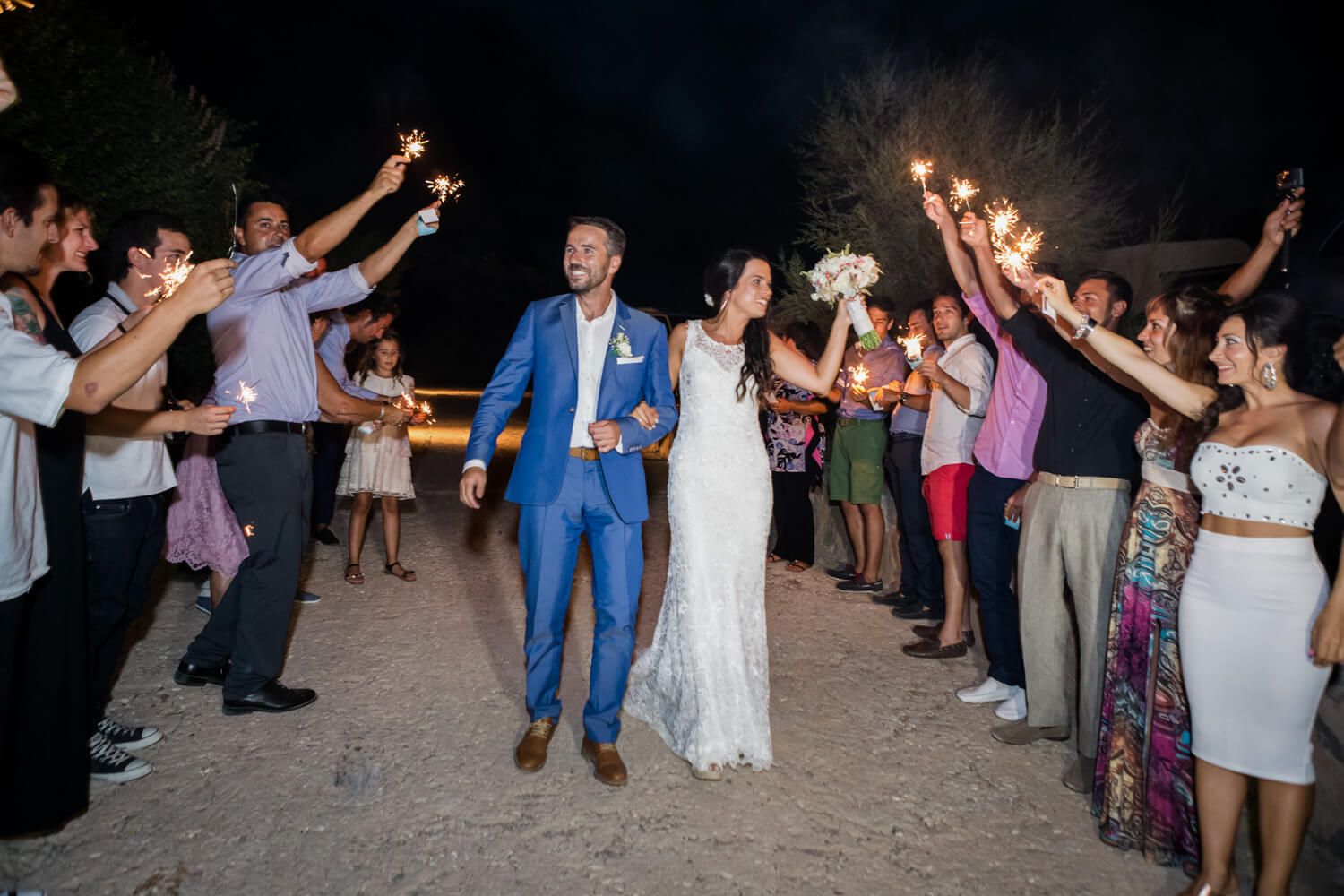 Couple entering the reception venue with fireworks