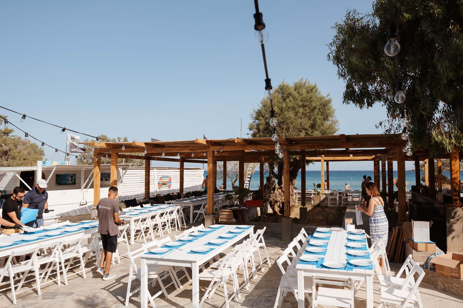 Wide shot of beautiful wedding reception decor and table settings at Rebel Bar Paros
