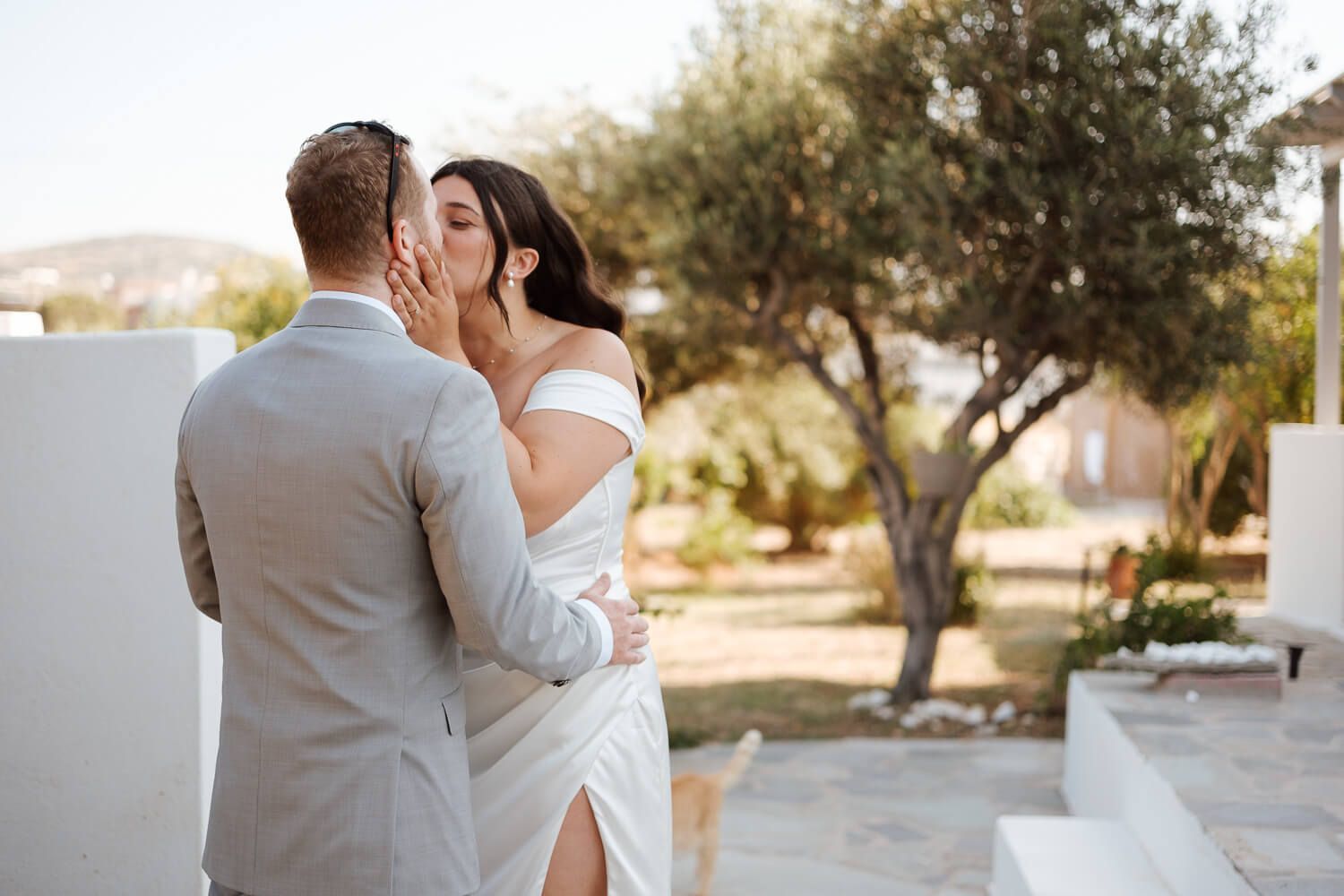 First kiss of the bride and groom after first look at a hotel in Naousa Paros