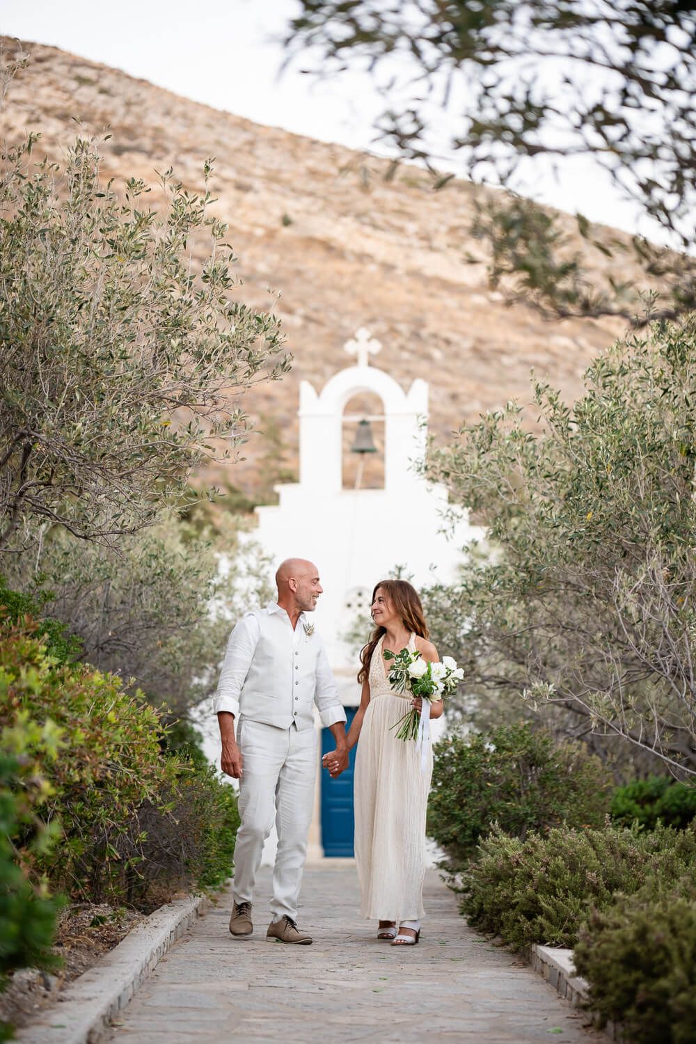 Joyful newlyweds walking together after their small wedding ceremony