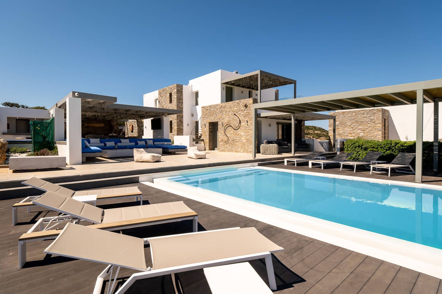 Sun loungers and modern exterior design at a luxury Paros property