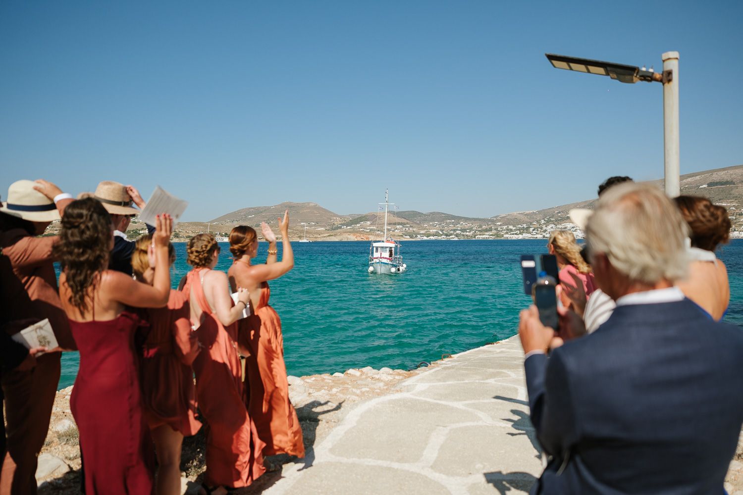 Bride arriving by boat at Agios Fokas chapel Paros