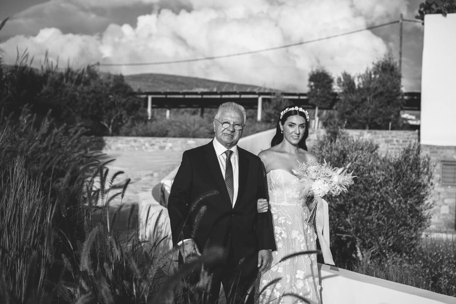 bride escorted by her father during a symbolic ceremony at Seesoo Paros Hotel