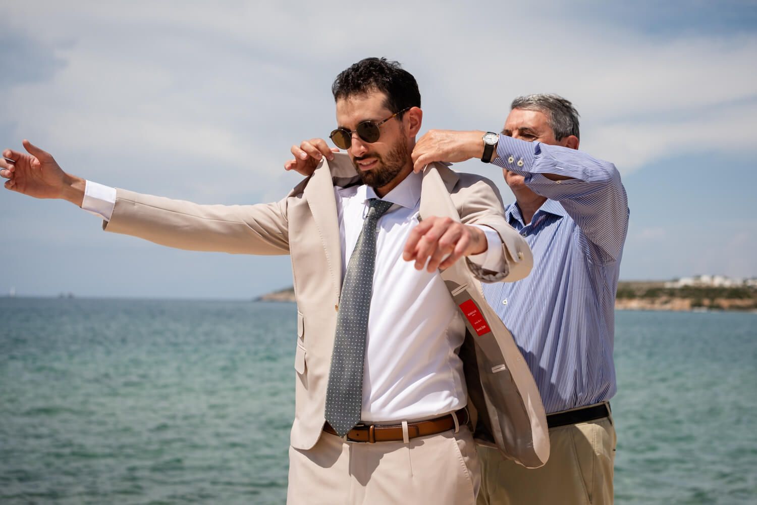 Candid groom preparation moments captured by Paros wedding photographer