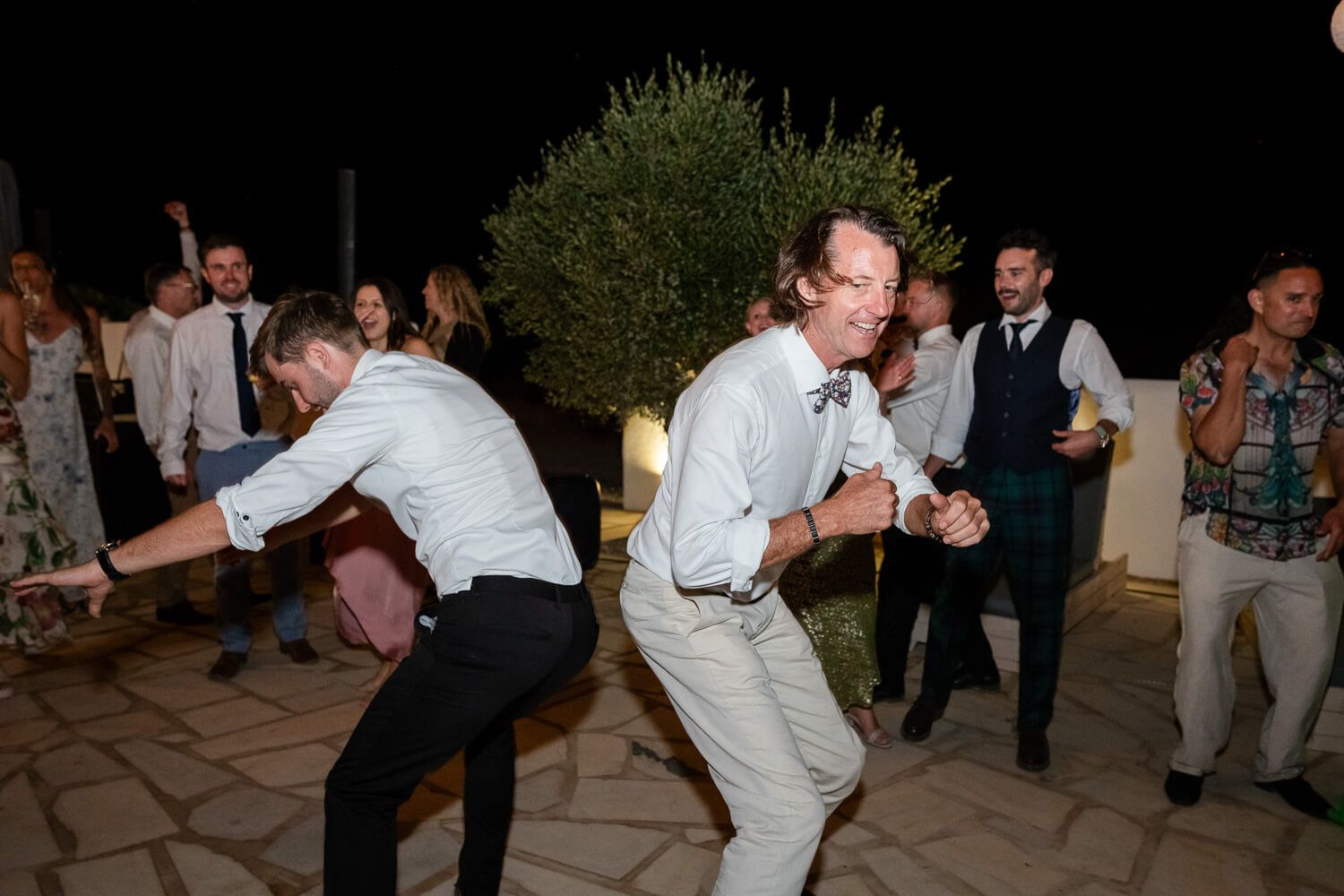 High-energy wedding party starting at an outdoor venue in Paros