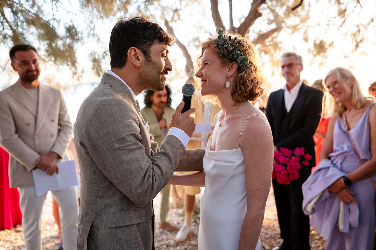 The couple exchanging vows with the sound of the waves in Paros