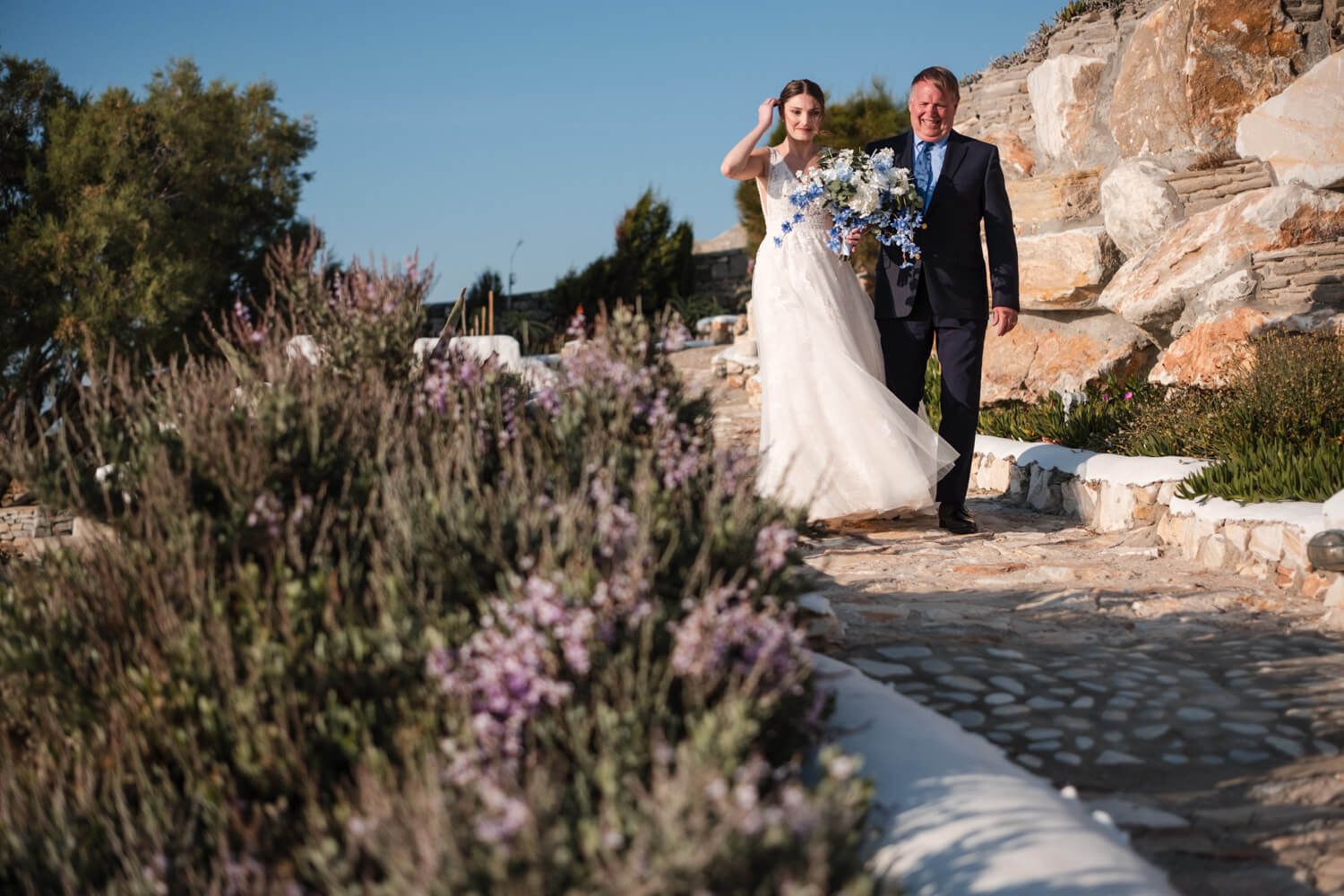 Bride Lizzy walking to her symbolic wedding ceremony in Greece