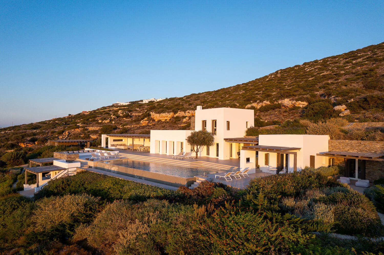 Minimalist building facade of a premium Mediterranean residence at sunset