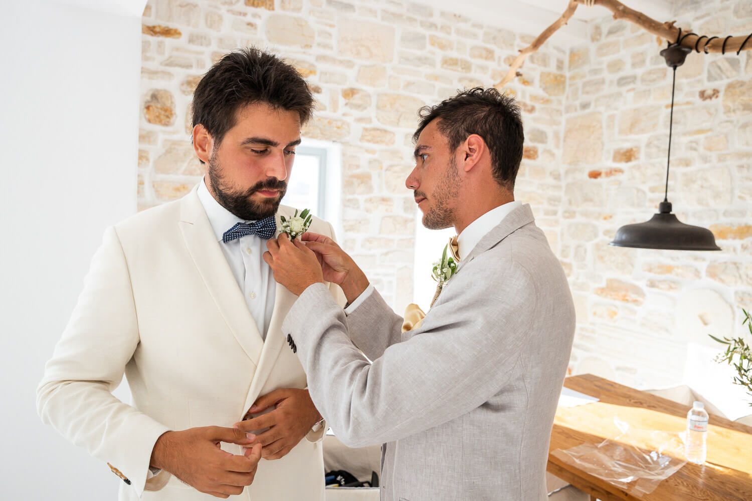 Paros wedding photographer capturing groom preparation at Villa Aethra