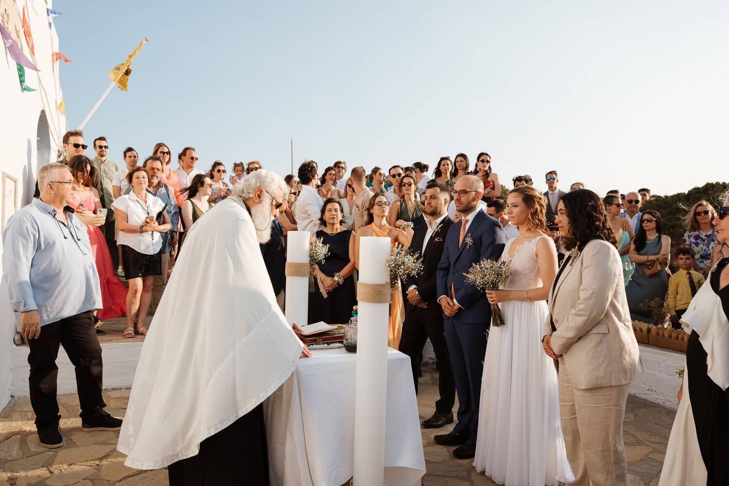 Beautiful Orthodox wedding ceremony under the bright Aegean sun
