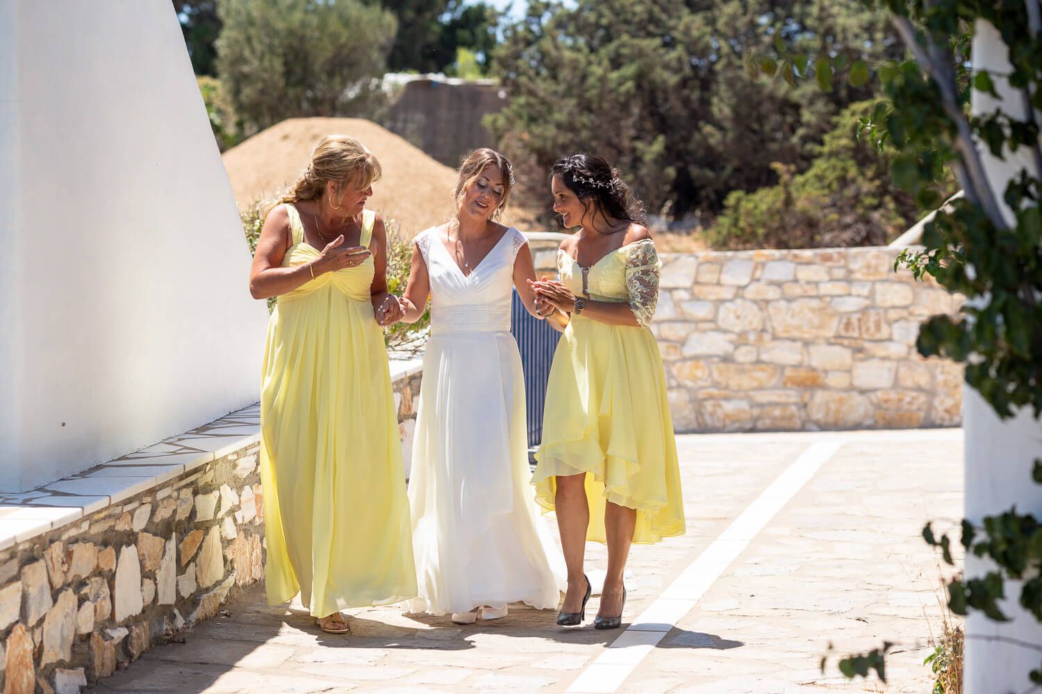 Bride smiling with her bridesmaids before the symbolic ceremony in Paros