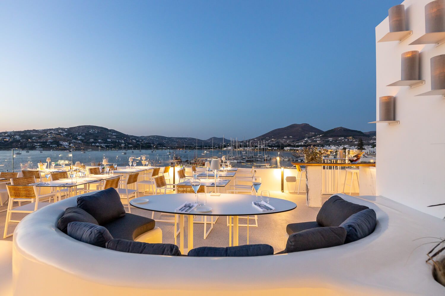 Nighttime framing of a high-end rooftop venue in the Cyclades