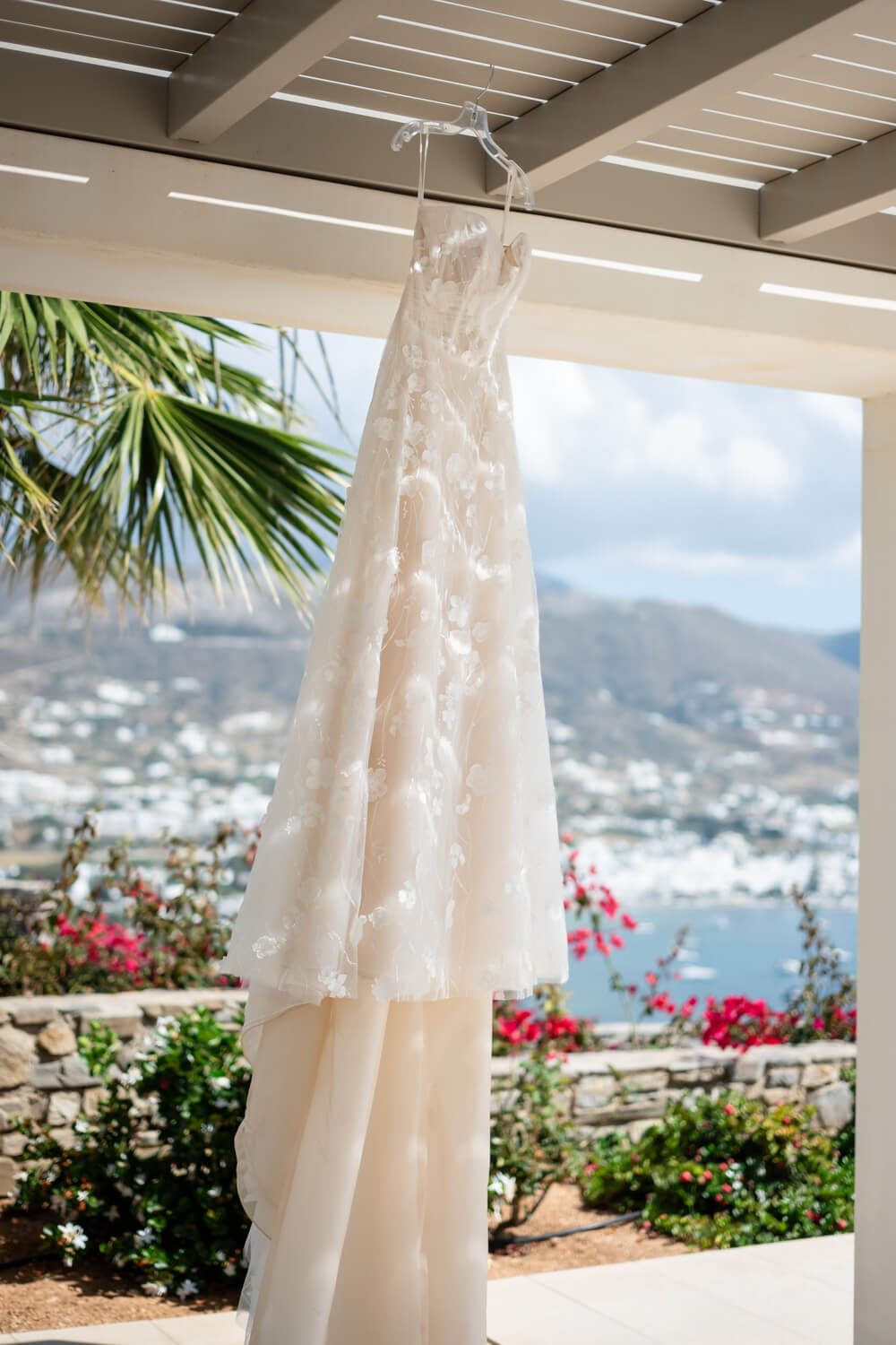 Elegant wedding dress details hanging at a seaside Paros villa