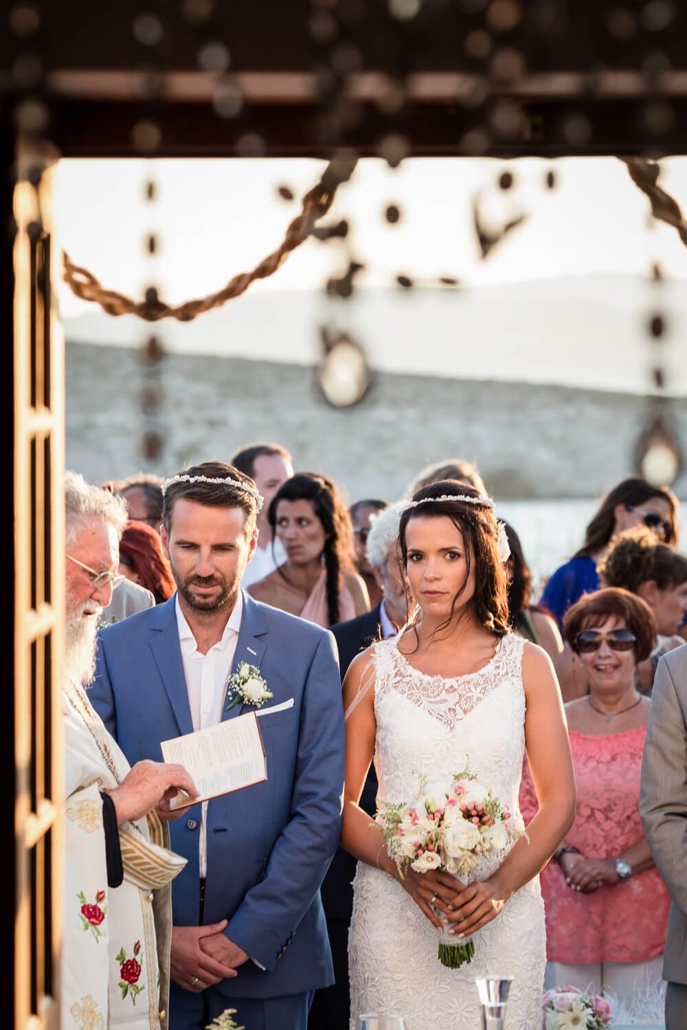 Spanish-Greek wedding ceremony in a white chapel in Milos