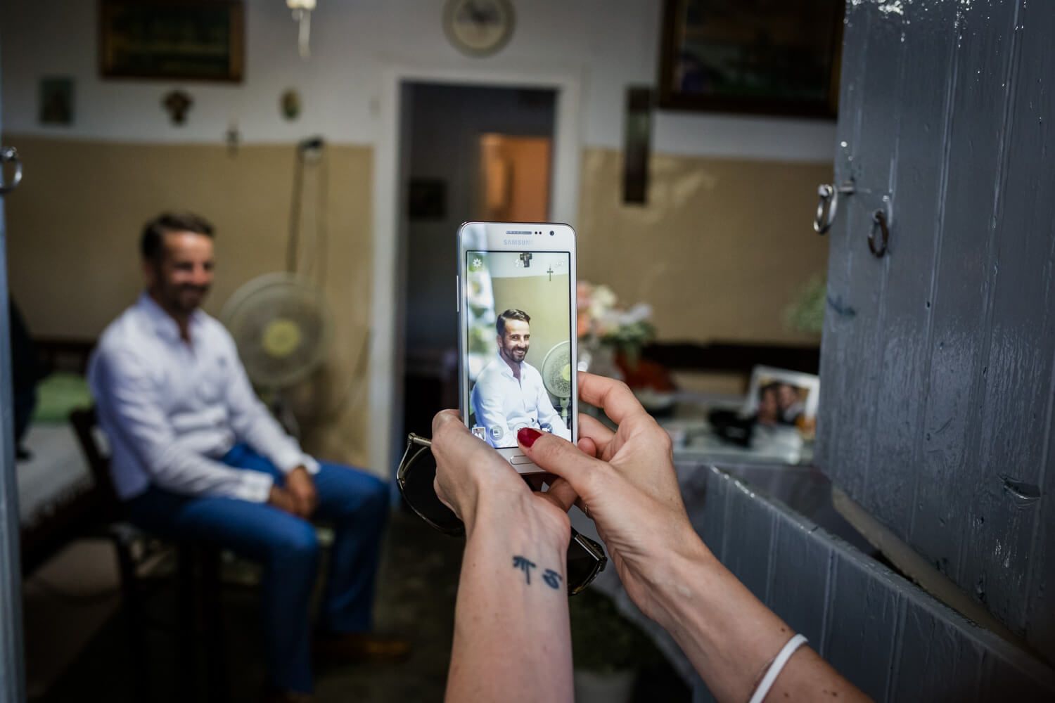 Groom getting ready at his grandmother's traditional house in Pachena Milos