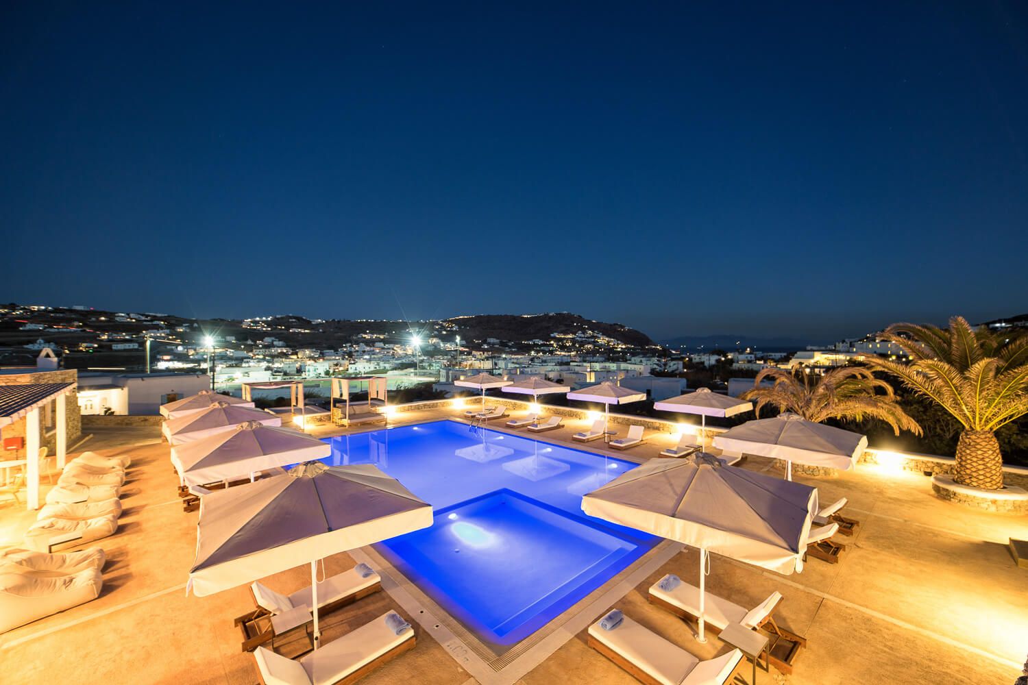 The serene evening atmosphere around the illuminated main pool