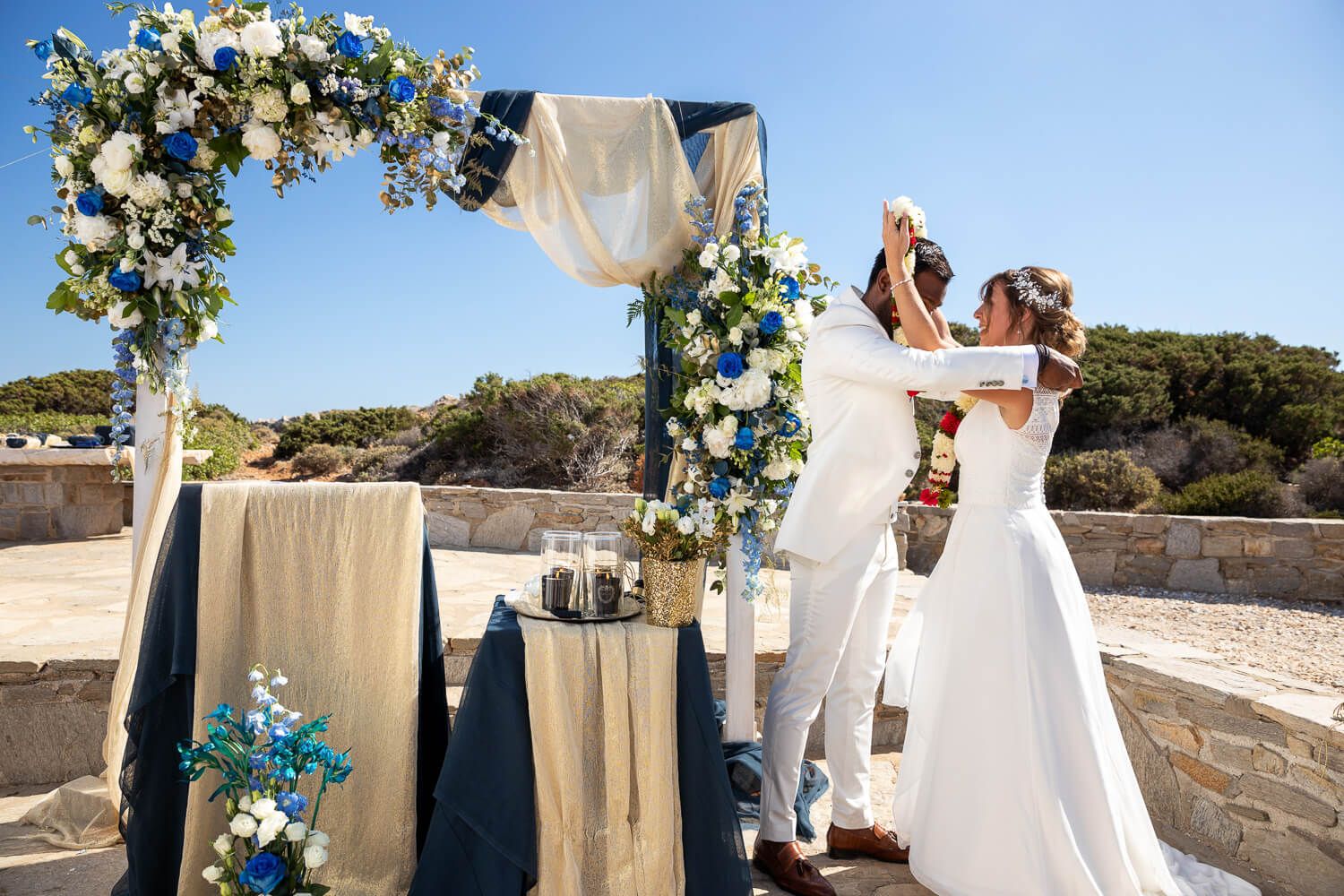 Couple holding hands during their symbolic wedding ceremony at Pyrgaki Paros