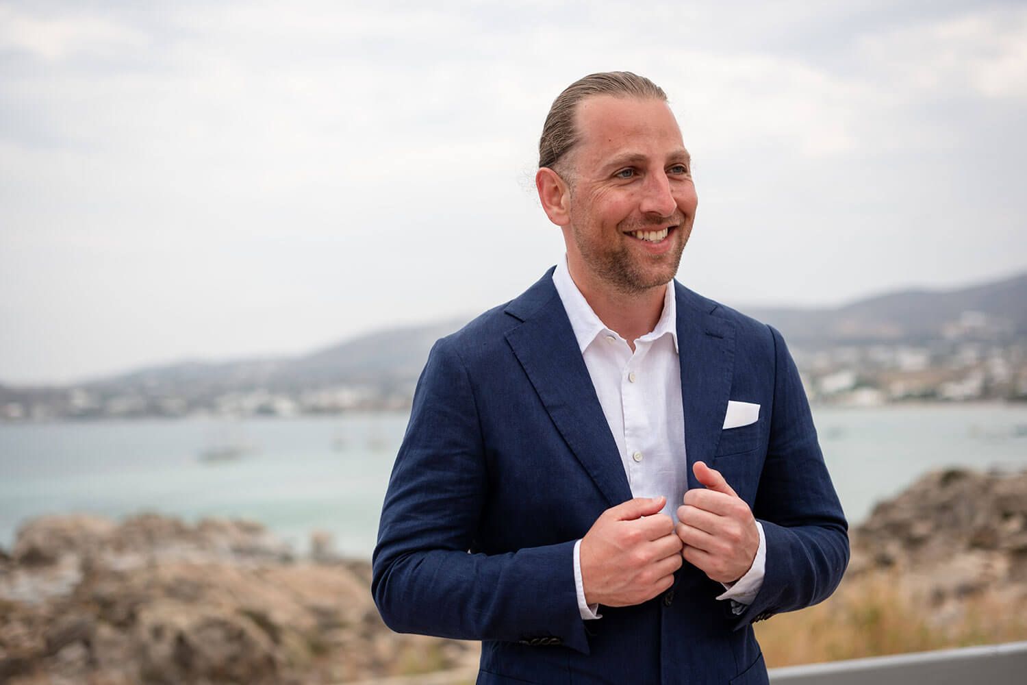 Groom having a relaxed moment on the villa terrace in Paros
