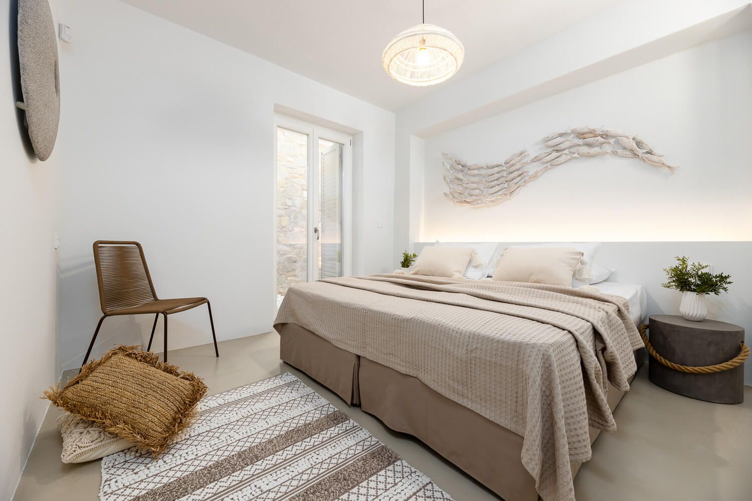 Crisp linen textures and premium bedding in a luxury suite in Paros