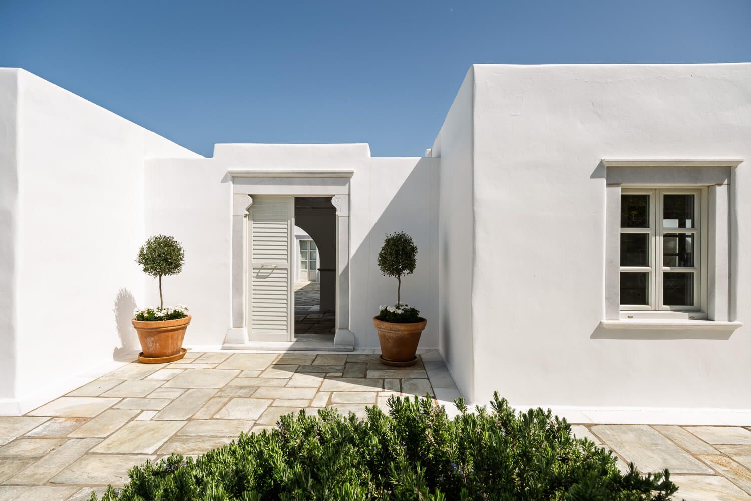 The welcoming entrance and classic facades of a large Paros home