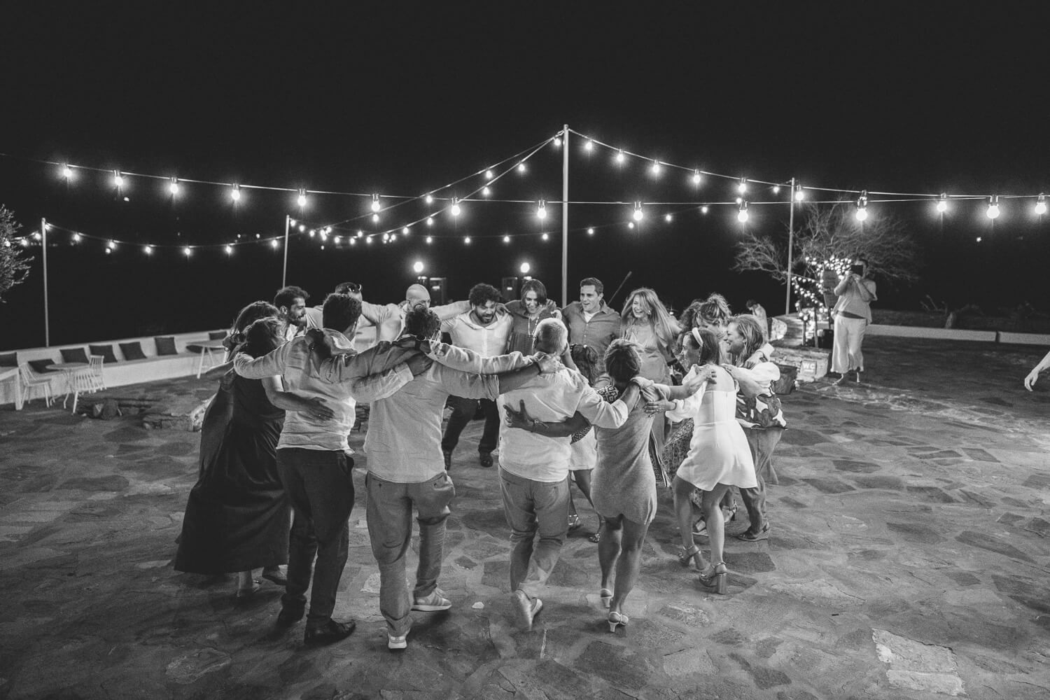 High-energy wedding party starting with traditional Greek island dancing