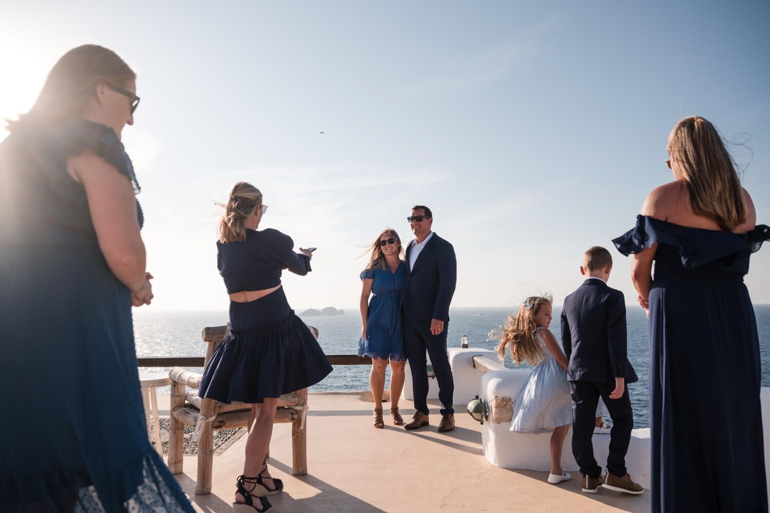 Guests taking photos before an intimate wedding ceremony overlooking the sea at Villa Lady of Paros
